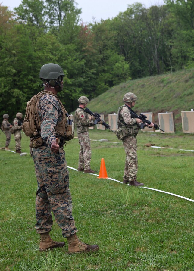 U.S. Marine Staff Sgt. Leon D. Austin, utilities chief with Inspector Instructor Staff, Engineer Support Company, 6th Engineer Support Battalion, 4th Marine Logistics Group, Marine Forces Reserve, gives the ready signal for the firing line of integrated Marines with 6th ESB, 4th MLG, MFR, and British commandos with 131 Commando Squadron Royal Engineers, British army, during exercise Red Dagger at Fort Indiantown Gap, Pa., May 14, 2018. Exercise Red Dagger is a bilateral training exercise that gives Marines an opportunity to exchange tactics, techniques and procedures as well as build working relationships with their British counterparts. (U.S. Marine Corps photo by Sgt. Melanie Wolf/Released)