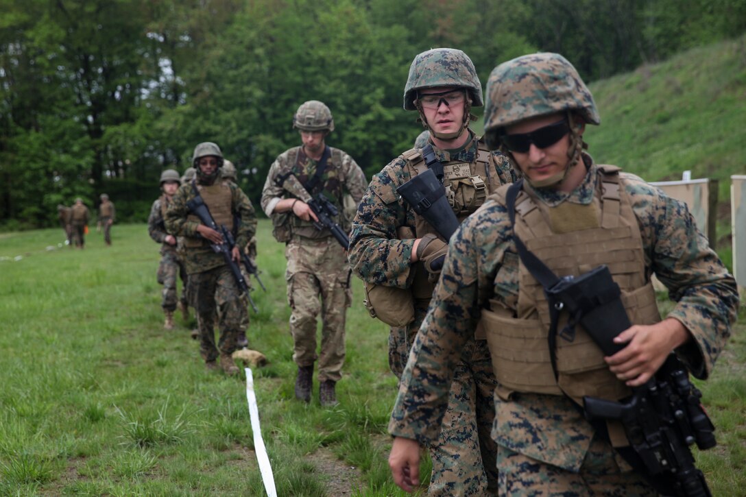 U.S. Marines with 6th Engineer Support Battalion, 4th Marine Logistics Group, Marine Forces Reserve, and British commandos with 131 Commando Squadron Royal Engineers, British army, exit the firing line after shooting tables five and six at the rifle range during exercise Red Dagger at Fort Indiantown Gap, Pa., May 14, 2018.