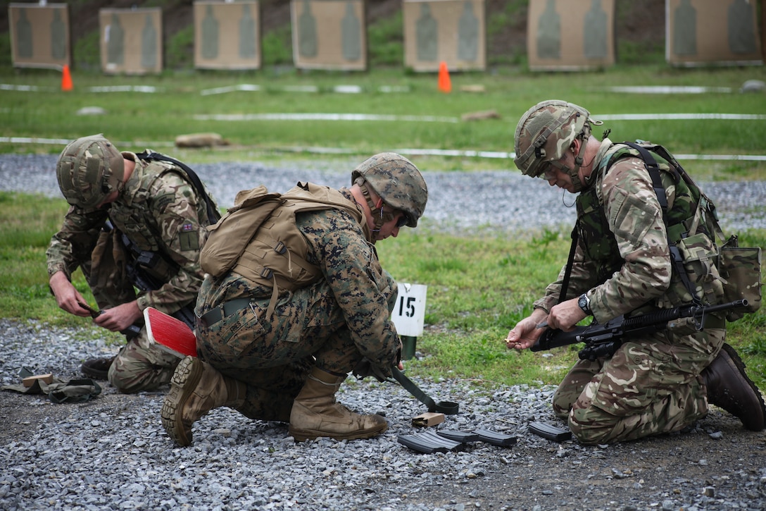 U.S. Marine Sgt. Steven J. Fries, metal worker with Engineer Support Company, 6th Engineer Support Battalion, 4th Marine Logistics Group, Marine Forces Reserve, helps British army Lance Cpl. Christopher C. Lane, British commando with 131 Commando Squadron Royal Engineers, British army, load his magazine with live ammunition during exercise Red Dagger at Fort Indiantown Gap, Pa., May 14, 2018.