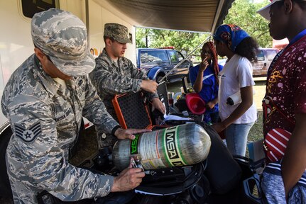Staff Sgt. Harry Sayan Diaz, 628th Civil Engineer Squadron emergency management member, teaches attendees about tools used in his career field during the fourth annual Federal Executive Association Government Expo May 11, 2018, at Liberty Square, Charleston, S.C.