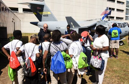 Tech. Sgt. Jared Bryant, U.S.Air Force recruiter, talks to kids about the Air Force during the fourth annual Federal Executive Association Government Expo May 11, 2018, at Liberty Square, Charleston, S.C.
