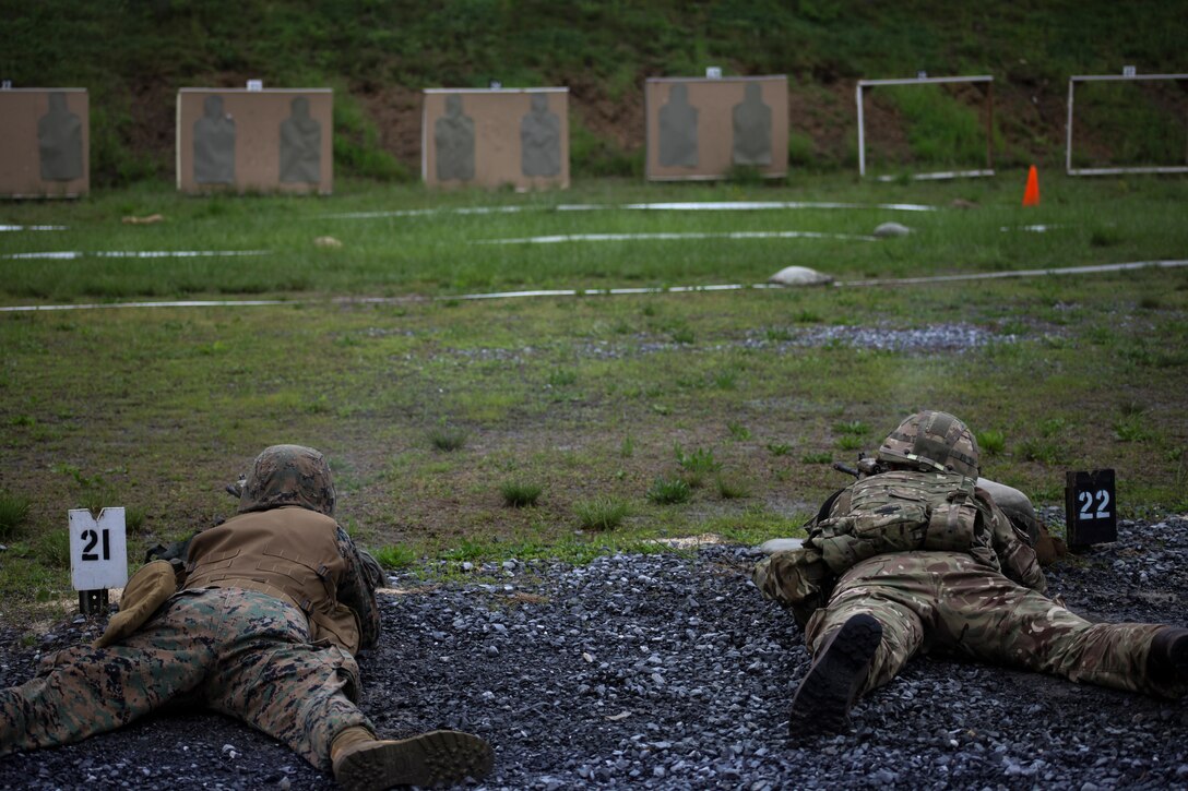 U.S. Marine Lance Cpl. Joshua D. Southern, combat engineer with Bridge Company Charlie, 6th Engineer Support Battalion, 4th Marine Logistics Group, Marine Forces Reserve, and British army 1st Lt. Andrew Wiltshire, British commando with 131 Commando Squadron Royal Engineers, British army, fire in the prone position during a live fire range of tables five and six during exercise Red Dagger at Fort Indiantown Gap, Pa., May 14, 2018.