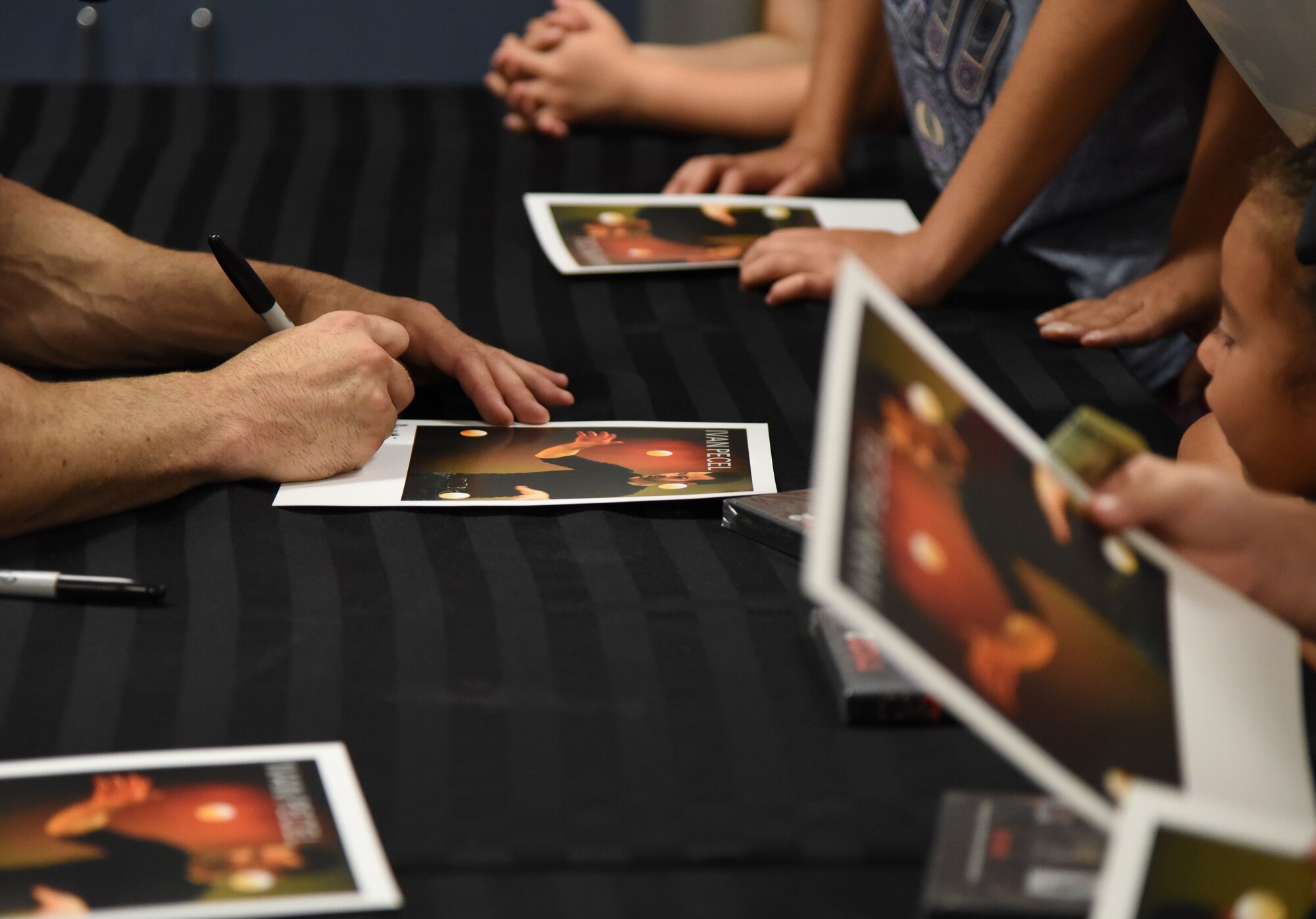 Ivan Pecel, juggler, signs autographs following his show at the Welch Theater at Keesler Air Force Base, Mississippi, May 9, 2018. Pecel, an award winning juggler with more than 15 years of juggling experience, is also a comedian and performed during the first season of America’s Got Talent. The 81st Force Support Squadron and The Air Force Services Activity hosted the event. (U.S. Air Force photo by Kemberly Groue)