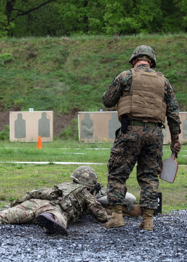 U.S. Marine Sgt. John R. Sheets, range coach with Inspector Instructor Staff, Engineer Support Company, 6th Engineer Support Battalion, 4th Marine Logistics Group, Marine Forces Reserve, helps British army 1st Lt. Andrew Wiltshire, British commando with 131 Commando Squadron Royal Engineers, British army, with his firing technique during the live fire ranges of tables five and six during exercise Red Dagger at Fort Indiantown Gap, Pa., May 14, 2018. Exercise Red Dagger is a bilateral training exercise that gives Marines an opportunity to exchange tactics, techniques and procedures as well as build working relationships with their British counterparts. (U.S. Marine Corps photo by Sgt. Melanie Wolf/Released)