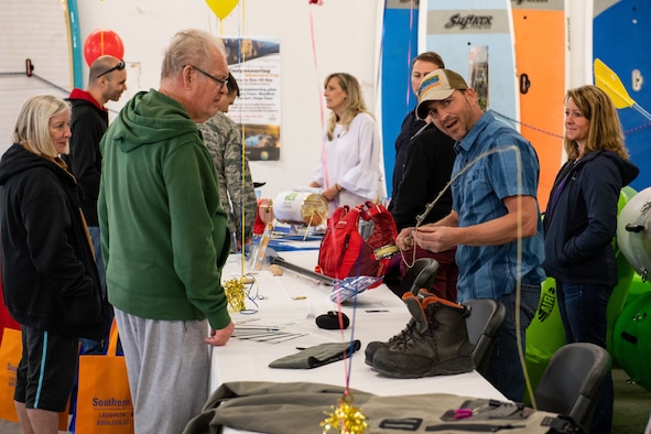 Matt Mravetz, Wasatch Adventure Guide, shows Bruce Petersen a fly rod during the Summer Expo May 11, 2018, at Hill Air Force Base, Utah. The event featured more than 40 informational booths highlighting on- and off-base services, cultural awareness information and resources in the area of travel and recreational opportunities. (U.S. Air Force photo by R. Nial Bradshaw)