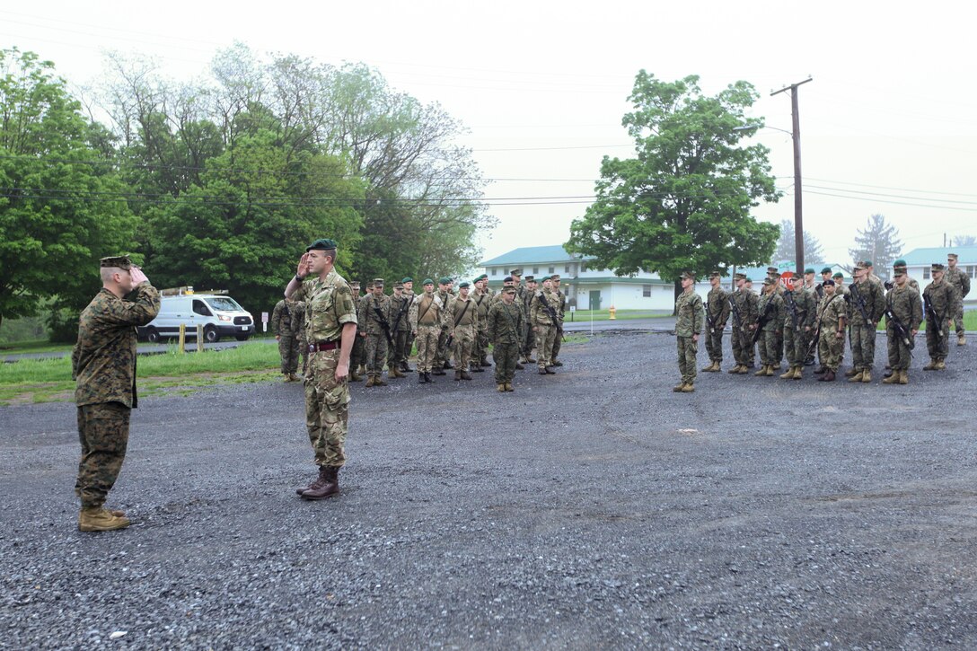 British army Staff Sgt. Nigel W. Oakley (right), non-commissioned officer in charge of exercise Red Dagger with 131 Commando Squadron Royal Engineers, British army, salutes U.S. Marine Maj. Timothy B. McGovney (left), company commander of exercise Red Dagger with 6th Engineer Support Battalion, 4th Marine Logistics Group, Marine Forces Reserve, at a formation held during exercise Red Dagger at Fort Indiantown Gap, Pa., May 14, 2018.