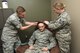 Capt. Daniel Gibson, 92nd Medical Operation Squadron psychologist, and Staff Sgt. Marisa Prokarym, 92nd Medical Operation Squadron NCO in charge Alcohol Drug Abuse Prevention Treatment, place a Nexxus Biotrace headpiece on Staff Sgt. Donald Durst, 92nd Aerospace Medicine Squadron aerospace medical technician, May 4, 2018 at Fairchild Air Force Base, Wash. The equipment allows patients to see how their body is responding to both physical and mental stress. (U.S. Air Force photo by Staff Sgt. Samantha Krolikowski)