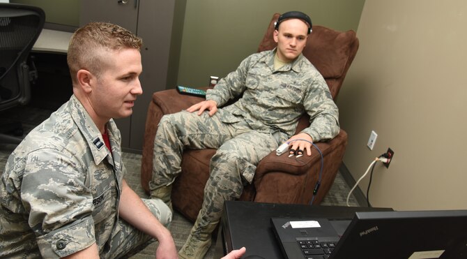 Capt. Daniel Gibson, 92nd Medical Operation Squadron psychologist, goes over the Nexxus Biotrace with Staff Sgt. Donald Durst, 92nd Aerospace Medicine Squadron aerospace medical technician, May 4, 2018 at Fairchild Air Force Base, Wash. The program allows patients to see how their body is responding to both physical and mental stress. The patient is able to visualize what his or her body is doing under stress and see how it differs when in a relaxed state. (U.S. Air Force photo by Staff Sgt. Samantha Krolikowski)