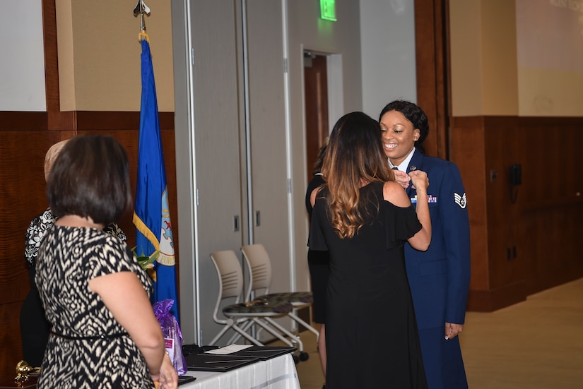 Staff Sgt. Kelvena Madison, 628th Medical Group dental hygienist, receives her hygienist pin after graduating from the Trident Technical College dental hygienist program, May 3, 2018 in Charleston, S.C.