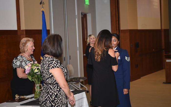 Staff Sgt. Tiffany Young, 628th Medical Group dental hygienist, receives her hygienist pin after graduating from the Trident Technical College dental hygienist program, May 3, 2018 in Charleston, S.C.