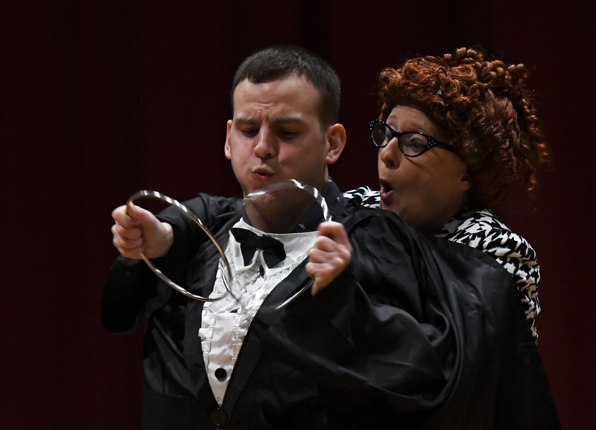 U.S. Air Force 2nd Lt. Jose Rodriguez Hernandez, 335th Training Squadron personnel student, and April Vollm, comedian, perform an act during the Ivan Pecel pre-show at the Welch Theater at Keesler Air Force Base, Mississippi, May 9, 2018. The 81st Force Support Squadron and The Air Force Services Activity hosted the event. (U.S. Air Force photo by Kemberly Groue)