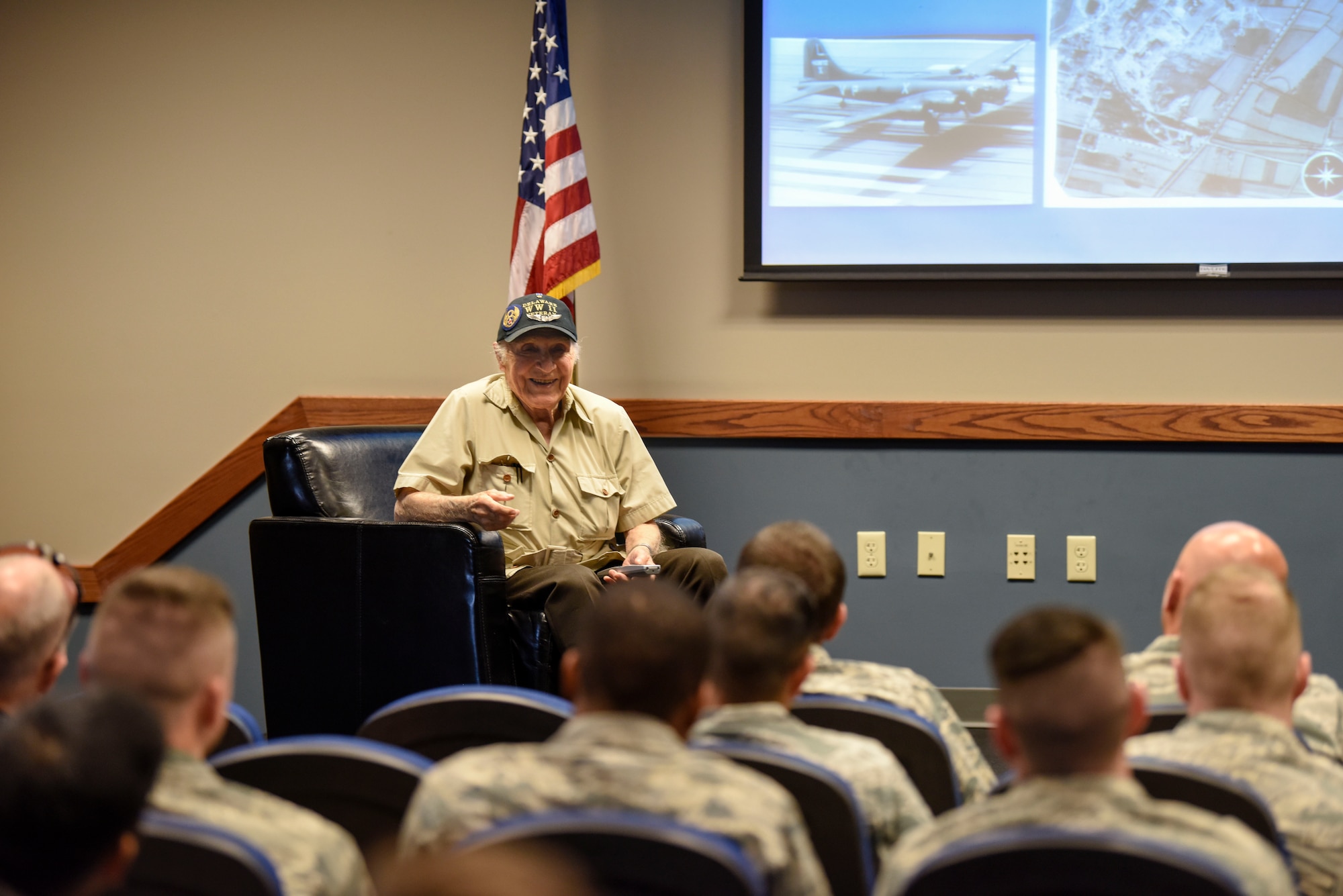 Retired Army Air Corps 1st Lt. Ray Firmani, World War II B-17 pilot, speaks at the quarterly Hangar Talk May 10, 2018, at Dover Air Force Base, Del. Firmani shared stories from his time as a pilot and the 25 combat missions he flew. (U.S. Air Force photo by Airman 1st Class Zoe M. Wockenfuss)