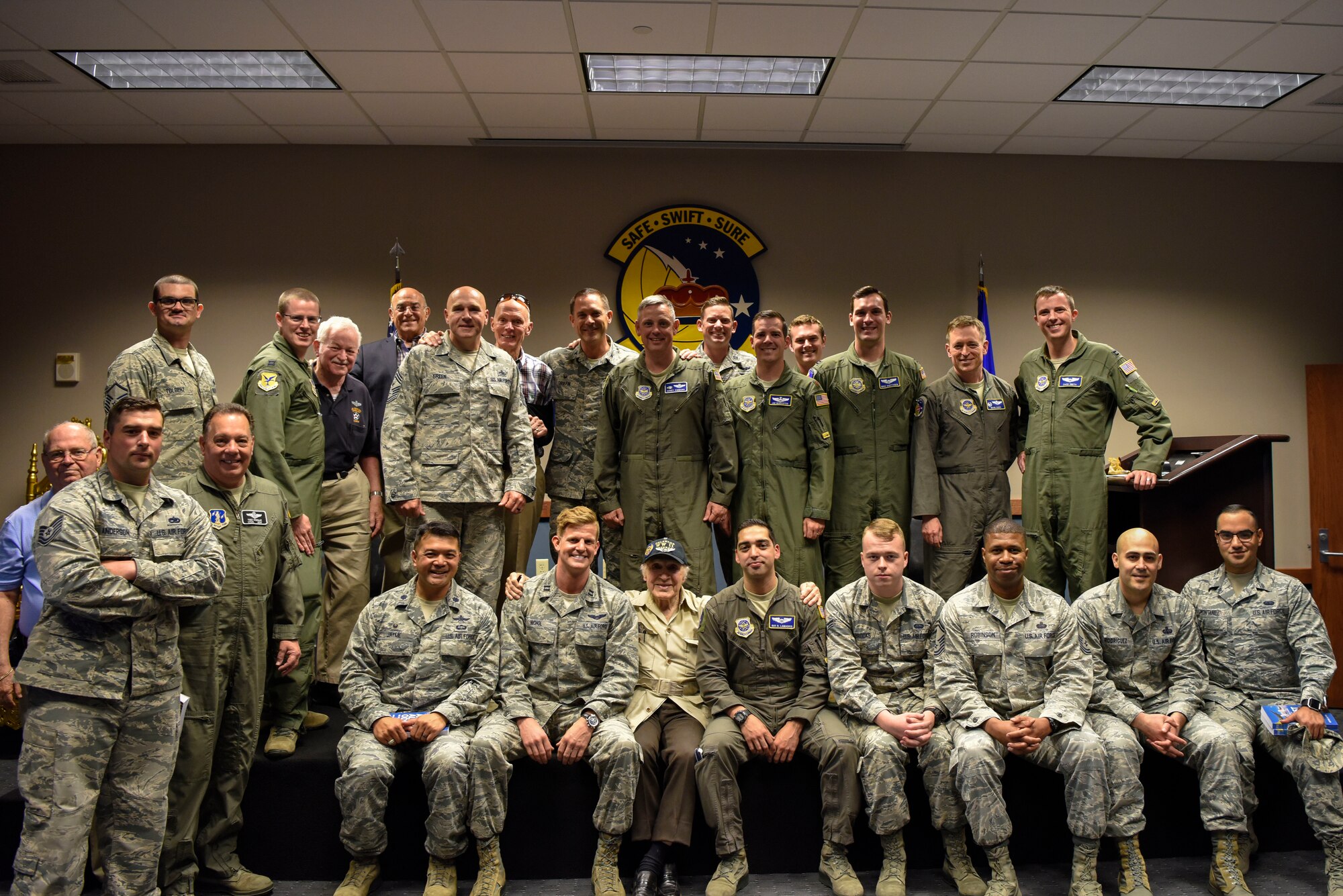 Retired Army Air Corps 1st Lt. Ray Firmani, World War II B-17 pilot, gets a photo with some of the attendees at the quarterly Hangar Talk May 10, 2018, at Dover Air Force Base, Del. This was the installation’s third such heritage event. (U.S. Air Force photo by Airman 1st Class Zoe M. Wockenfuss)