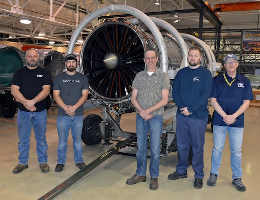 (Left to right) Marcus Moore, Korey Blundy, Warren Flick, Dustin Troutman and Rick Emlet stand in front of a Pratt and Whitney F135 turbofan engine used in all variants of the F-35 Lightning II April 25, 2018, at Hill Air Force Base, Utah. (U.S. Air Force photo by Alex R. Lloyd)