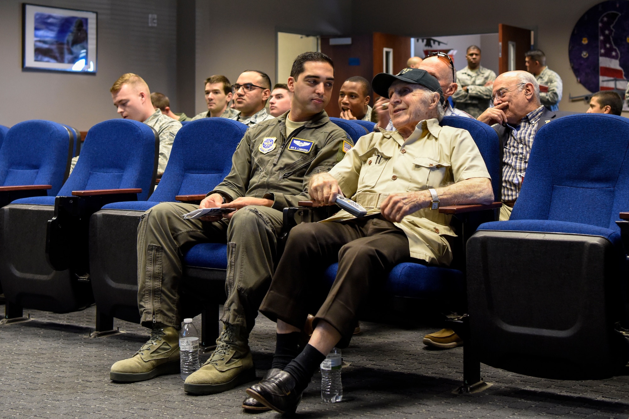 Capt. Gus Lamadrid, 3rd Airlift Squadron C-17 Globemaster III pilot, talks to retired Army Air Corps 1st Lt. Ray Firmani, World War II B-17 pilot, during the quarterly Hangar Talk May 10, 2018, at Dover Air Force Base, Del. Lamadrid led the discussion during the heritage event by hosting a question and answer session with Firmani. (U.S. Air Force photo by Airman 1st Class Zoe M. Wockenfuss)