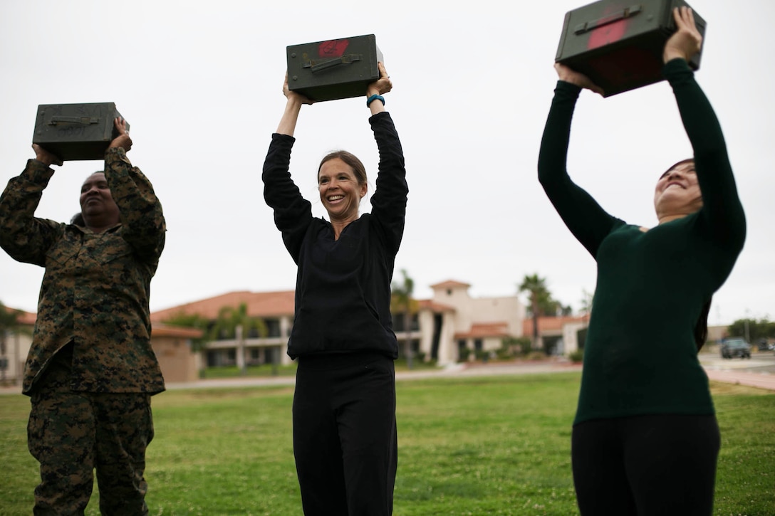 Military spouses conduct ammo can lifts during a mock combat fitness test during “Walk a Mile in Their Boots” at Marine Corps Air Station Miramar, Calif., May 11. “Walk a Mile in Their Boots” is an annual event that gives spouses the opportunity to experience some of the duties and responsibilities of their active duty counterparts. (U.S. Marine Corps photo by Lance Cpl. Mark A. Lowe/Released)