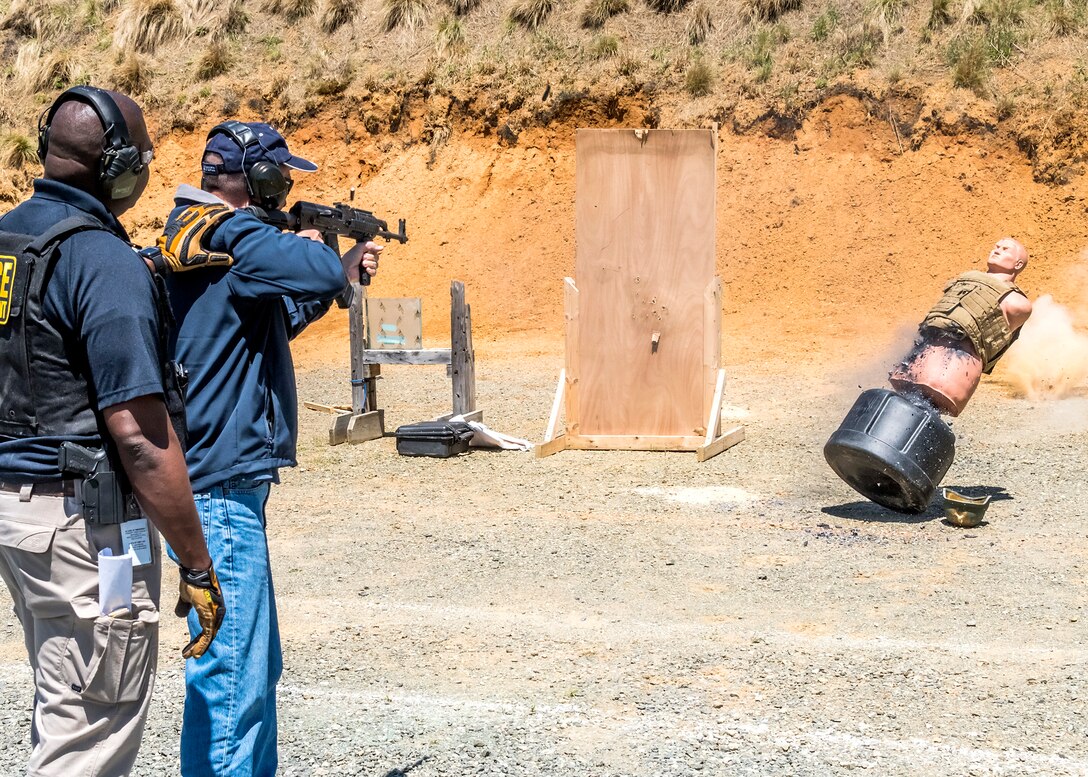 A participant fires an AK-47 with the guidance of Air Force Special Investigations Academy Instructor Special Agent Dwayne Harris during the weapons familiarization training of the Senior Leader Security Seminar at Montross, Va., April 30, 2018. The unique two-day anti-terrorism course ensures the safety and survivability of Air Force leaders traveling in medium to critical threat areas. (U.S. Air Force photo by Michael Hastings)