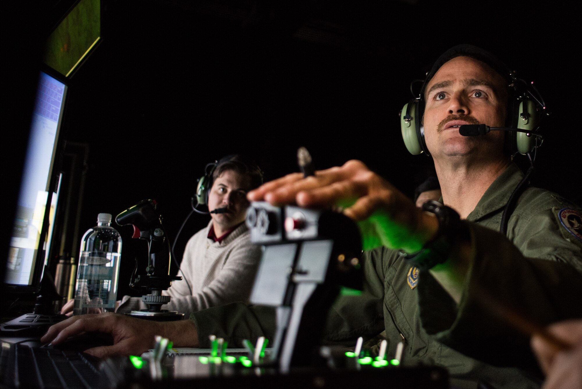 Lt. Col. Jason Smith, a pilot from the 301st Fighter Wing, Fort Worth, Texas, conducts a simulated flight mission while a tactical air control party specialist calls in an air strike during a simulated mission run by the 138th Combat Training Flight on an Air National Guard Advanced Joint Terminal Attack Controller Simulator at Will Rogers Air National Guard Base in Oklahoma City, Feb. 1, 2018. The simulator has saved the Air National Guard and Air Combat Command both time and money while ensuring the readiness of battlefield Airmen. (U.S. Air National Guard photo by Senior Airman Brigette Waltermire)