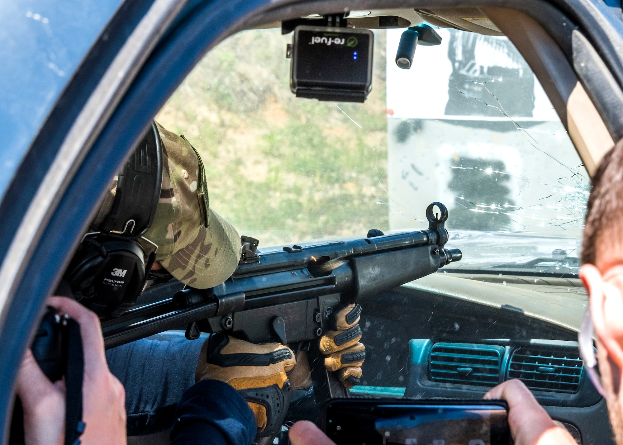 A participant fires an MP-5 from inside a vehicle during the weapons familiarization training of the Senior Leader Security Seminar at Montross, Va., April 30, 2018. The unique two-day anti-terrorism course ensures the safety and survivability of Air Force leaders traveling in medium to critical threat areas. (U.S. Air Force photo by Michael Hastings)