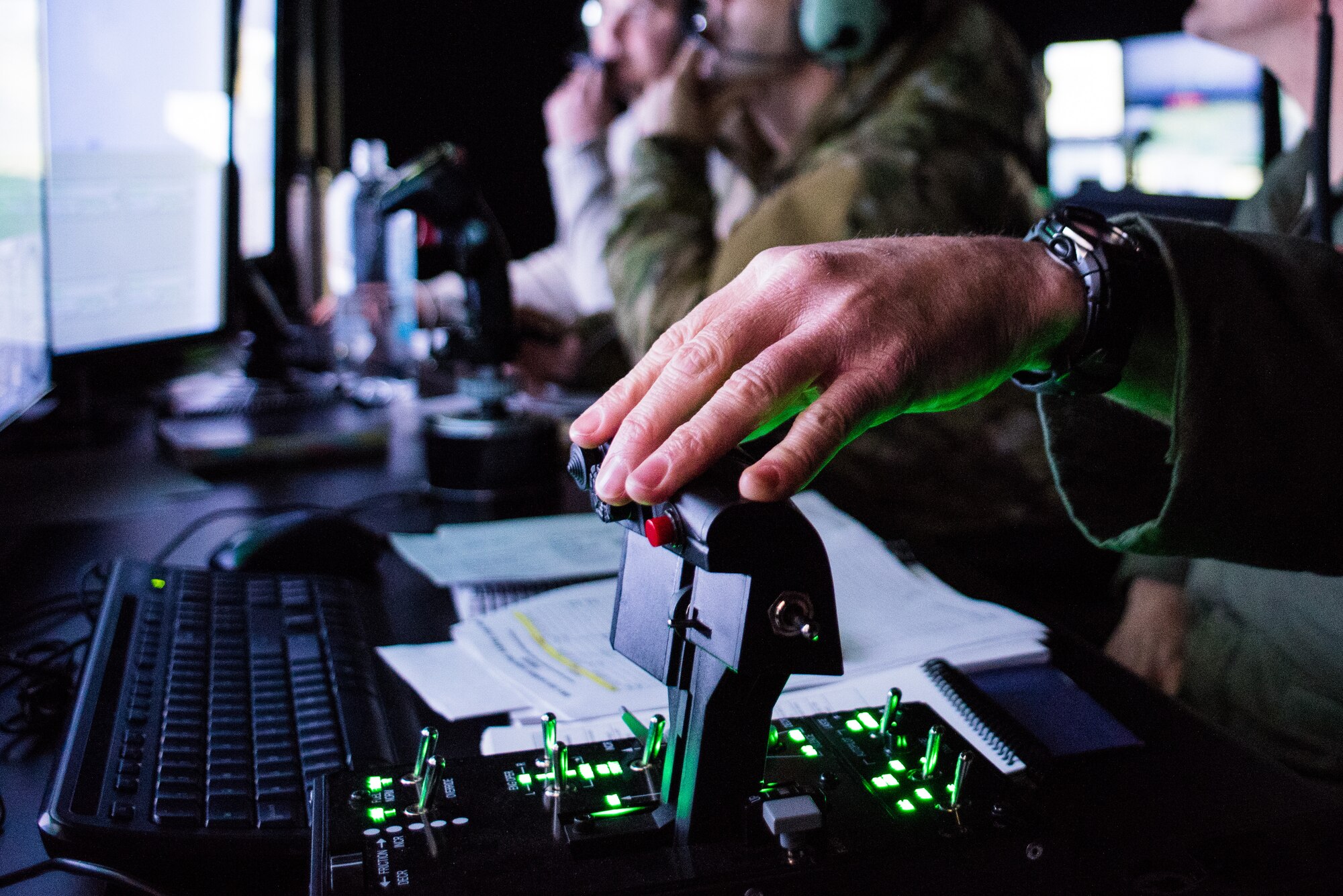 Lt. Col. Jason Smith, a pilot from the 301st Fighter Wing, Fort Worth, Texas, conducts a simulated flight mission while a tactical air control party specialist calls in an air strike during a simulated mission run by the 138th Combat Training Flight on an Air National Guard Advanced Joint Terminal Attack Controller Simulator at Will Rogers Air National Guard Base in Oklahoma City, Feb. 1, 2018. The simulator has saved the Air National Guard and Air Combat Command both time and money while ensuring the readiness of battlefield Airmen. (U.S. Air National Guard photo by Senior Airman Brigette Waltermire)