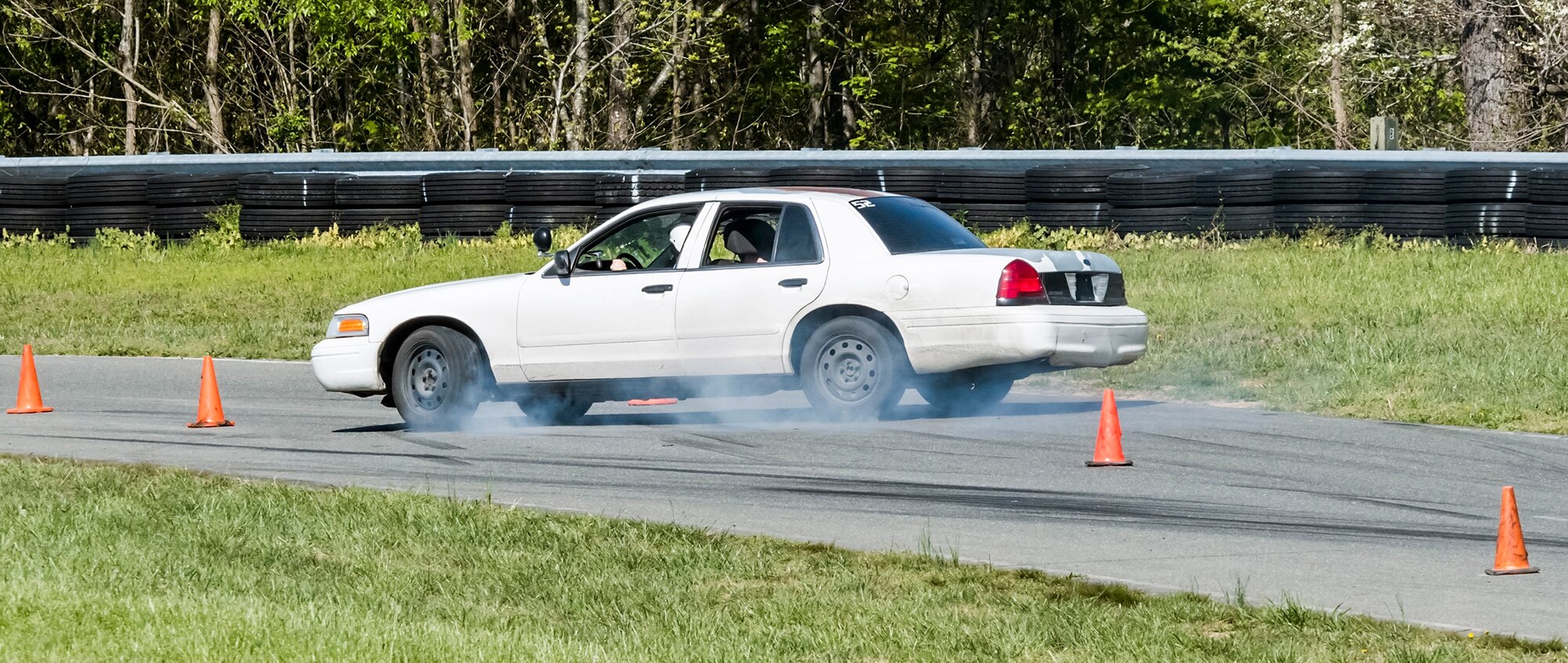 Participants demonstrate high-speed skid control technique during the instinctive driving training of the Senior Leader Security Seminar at Montross, Va., May 1, 2018. The unique two-day anti-terrorism course ensures the safety and survivability of  Air Force leaders traveling in medium to critical threat areas. (U.S. Air Force photo by Michael Hastings)