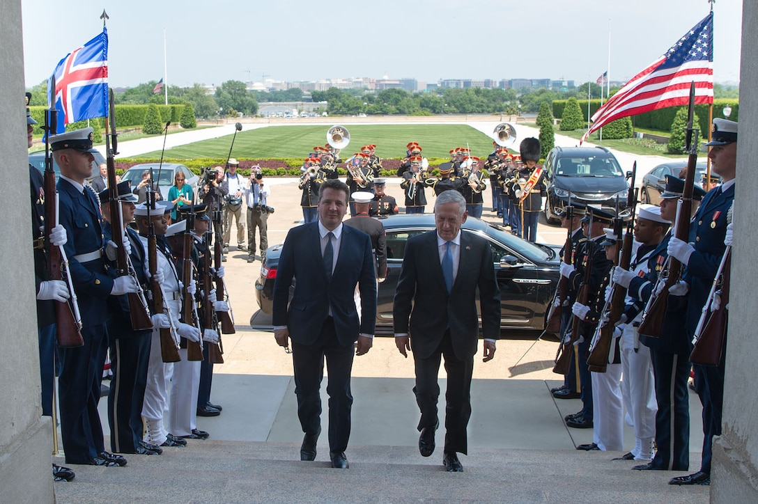 Defense Secretary James N. Mattis walks up the steps with Icelandic Minister.