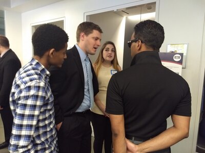 Stephen Shepherd (center left), a mechanical engineer with Naval Surface Warfare Center, Carderock Divisions Maritime Systems Hydromechanics Branch, discusses potential uses for an invention by a Navy engineer for the underwater towing of marine vessels, with attendees of the final Fed Tech event May 8, 2018, in Washington, D.C. (U.S. Navy photo by Dr. Joseph Teter/Released)