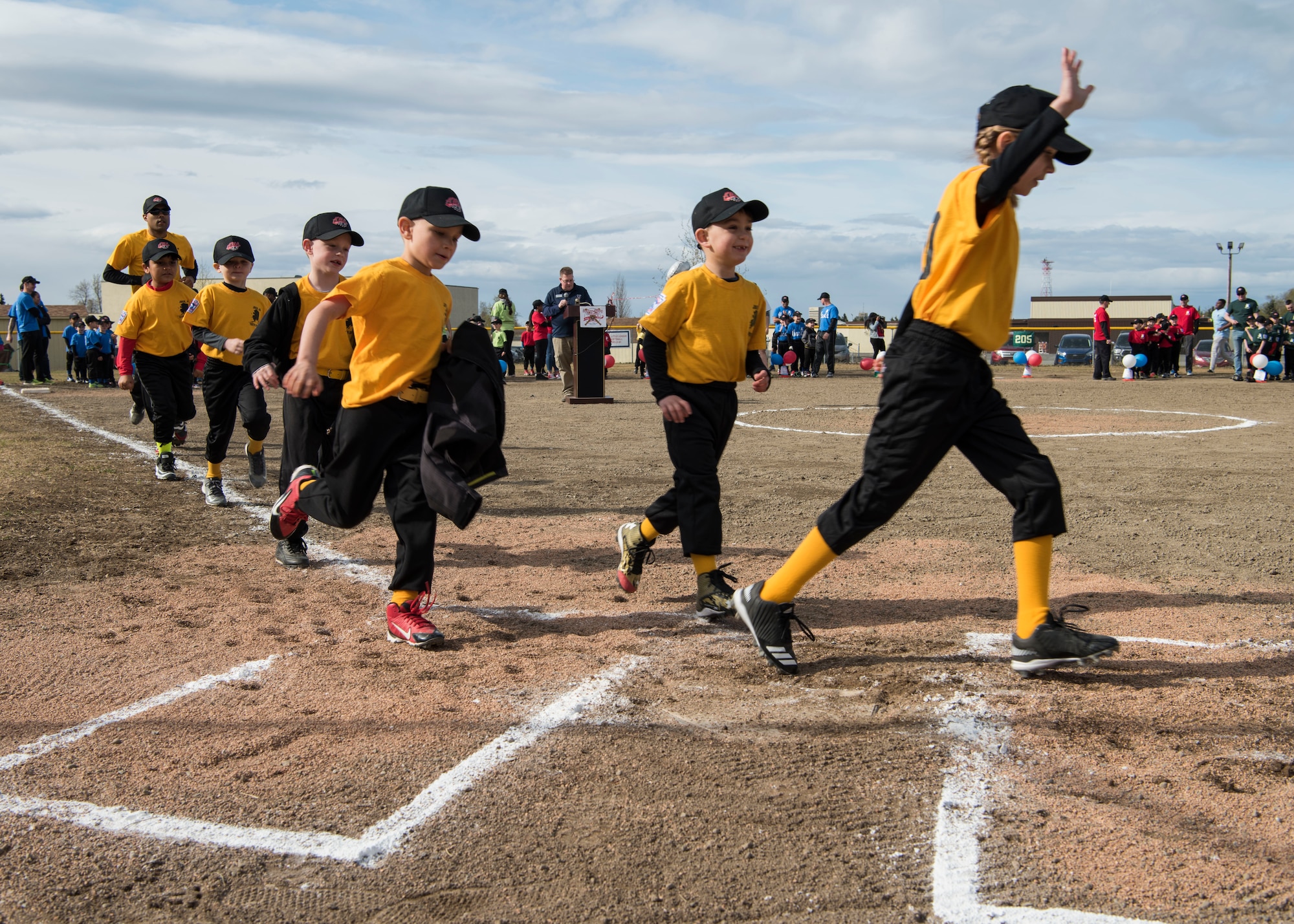 The Lions T-Ball team runs the bases during the Little League opening day ceremony at Joint Base Elmendorf-Richardson, Alaska, May 12, 2018. The ceremony included the posting of the colors, the national anthem, guest speakers – to include the coach and youth of the year winners. All games started immediately following the ceremony and continued throughout the day.