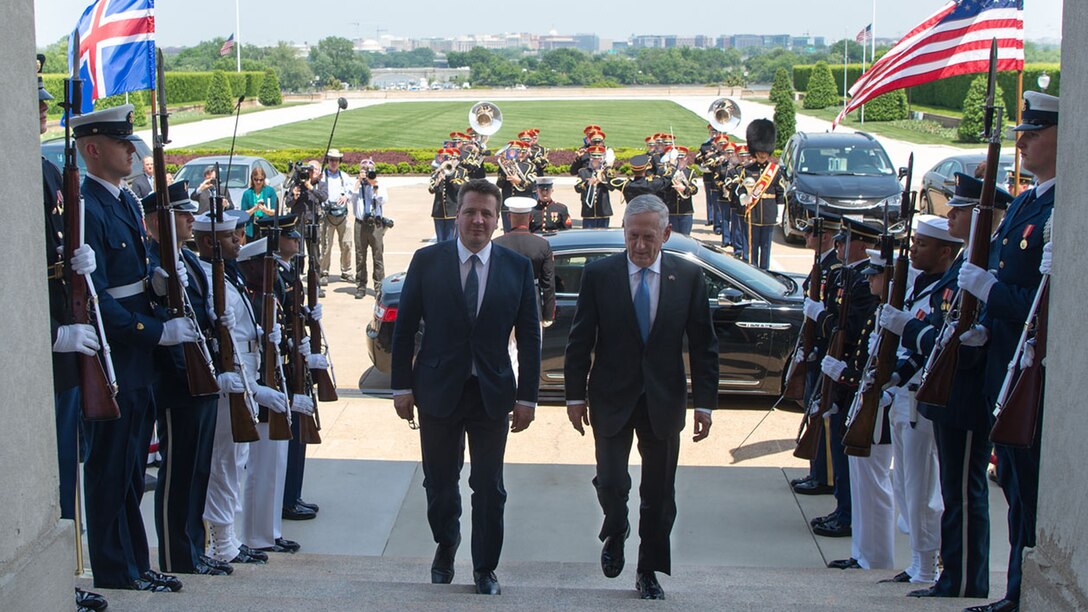 Defense Secretary James N. Mattis walks up the steps of the Pentagon with the Icelandic Foreign Minister.