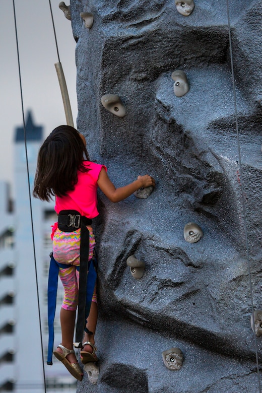 A child climbs to the top of the rock wall in Fun Land during Foster Fest May 12 aboard Camp Foster, Okinawa, Japan. The annual festival allowed members of the community to enjoy food, games and music. More than 13,000 people attended the two-day event. (U.S. Marine Corps photo by Pfc. Nicole Rogge)