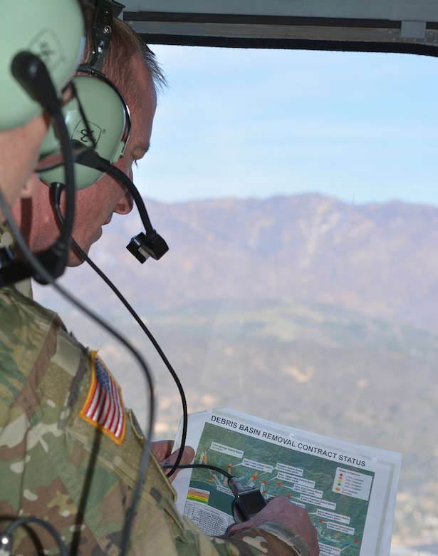 Col. Kirk Gibbs, U.S. Army Corps of Engineers Los Angeles District commander, views a map of the basins where the Corps is working on removing debris while flying over the area in a UH-60 Blackhawk helicopter over Santa Barbara County.