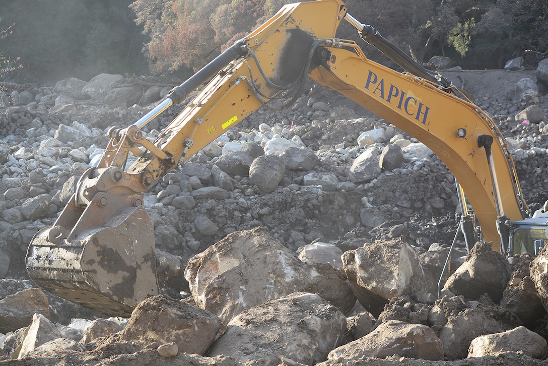 A bulldozer clears boulders out of the Cold Springs Creek Basin Jan. 18 in Montecito, California.