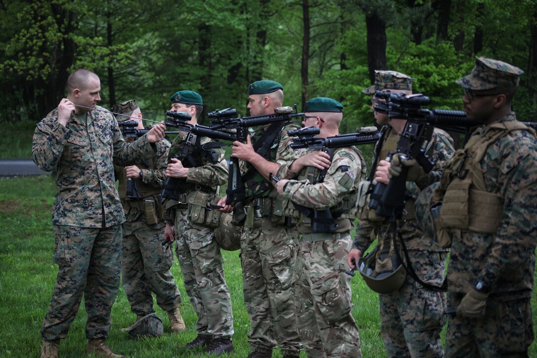 U.S. Marine Sgt. Travis J. Ganong, armorer with Inspector Instructor Staff, Engineer Support Company, 6th Engineer Support Battalion, 4th Marine Logistics Group, Marine Forces Reserve, punches the boar of the M16’s for an integrated platoon of Marines with 6th Engineer Support Battalion, 4th Marine Logistics Group, Marine Forces Reserve, and commandos with 131 Commando Squadron Royal Engineers, British army, during exercise Red Dagger at Fort Indiantown Gap, Pa., May 14, 2018.