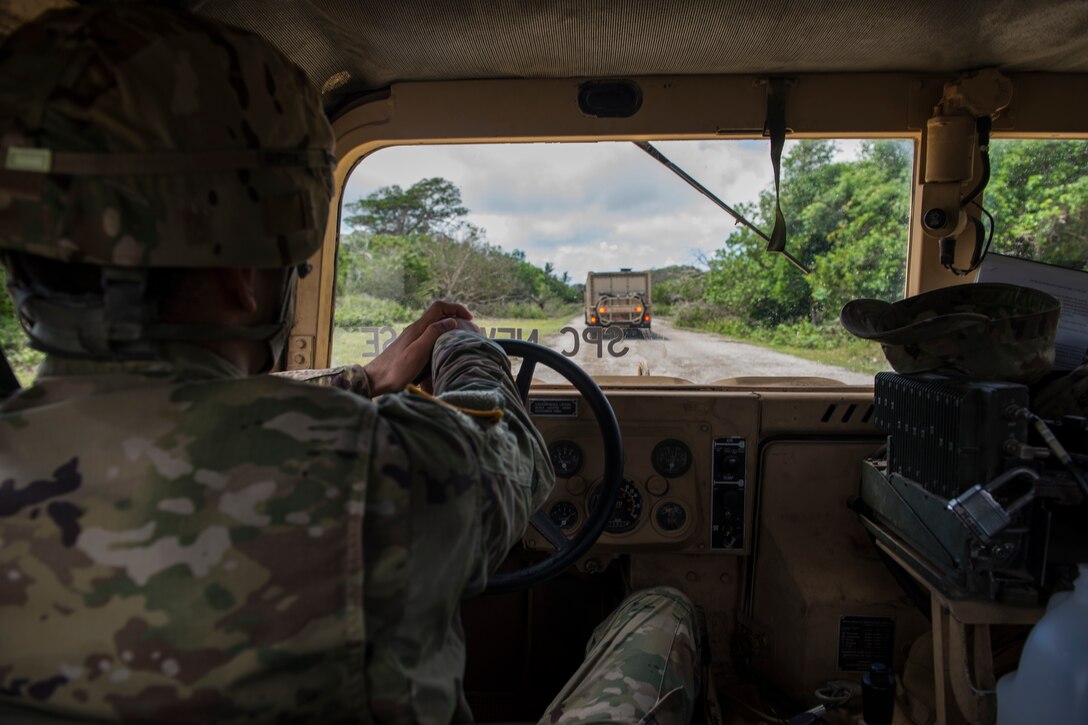 Soldiers assigned to the 94th Army Air and Missile Defense Command, Task Force Talon, travel in a convoy during a Typhoon readiness exercise, 9 May, 2018, on Andersen Air Force Base, Guam. The exercise allowed soldiers to coordinate and practice procedures they may have to implement to protect assets and personnel in the event of severe weather. (U.S. Air Force photo/Senior Airman Zachary Bumpus)