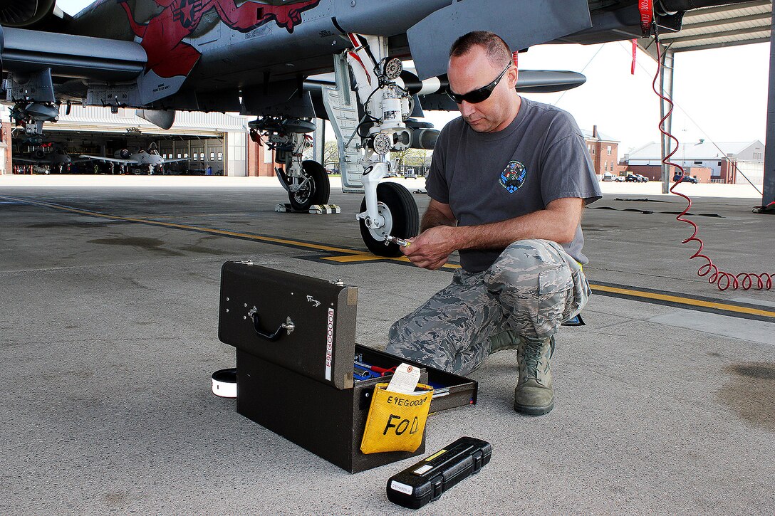 An airman puts away tools after performing maintenance.