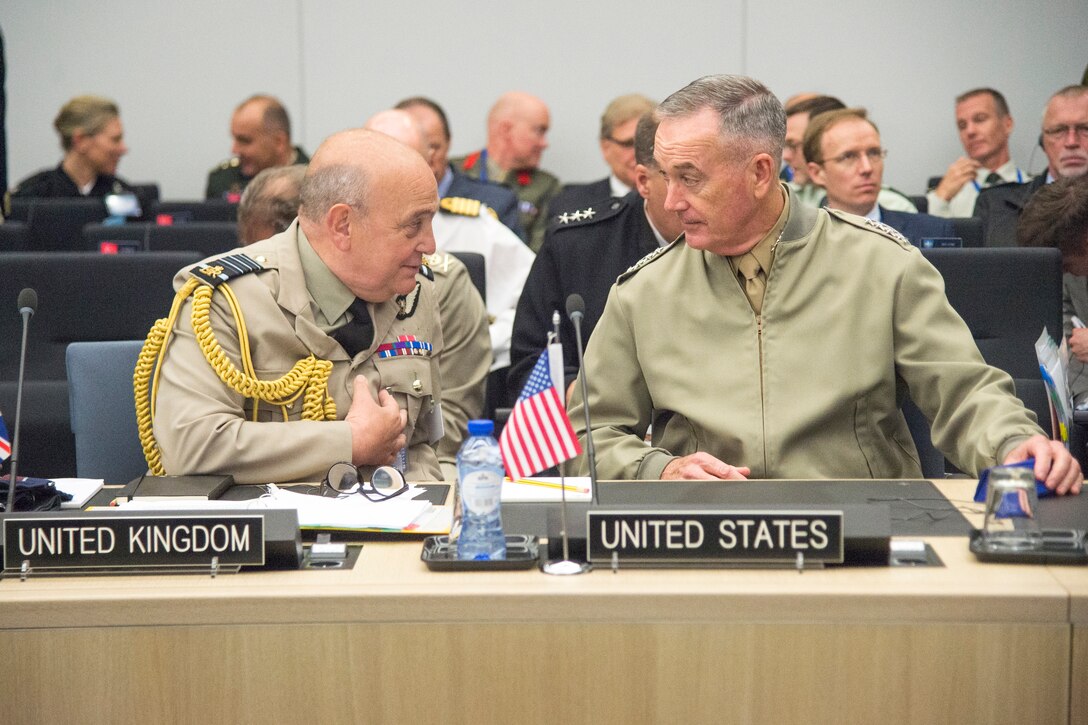 Two military leaders speak during NATO meetings in Brussels.
