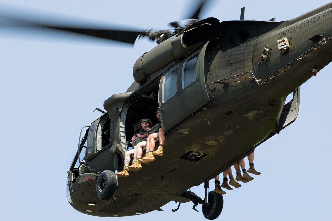 Soldiers ride in an Army UH-60 Black Hawk helicopter.