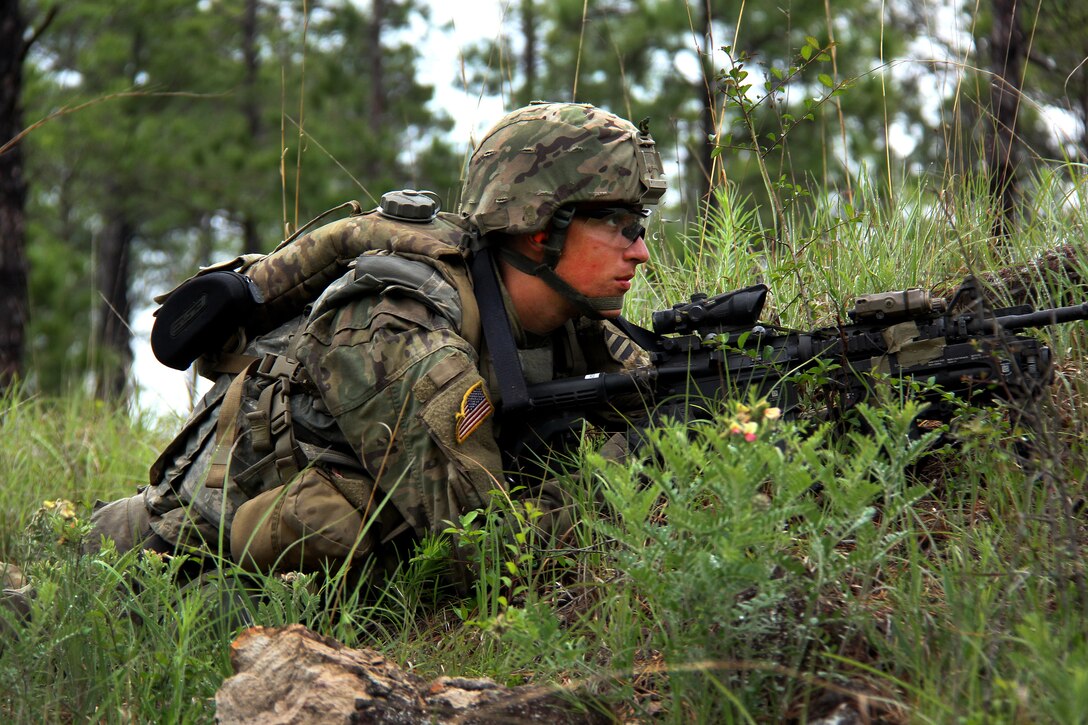 A soldier scans his sector while providing security.