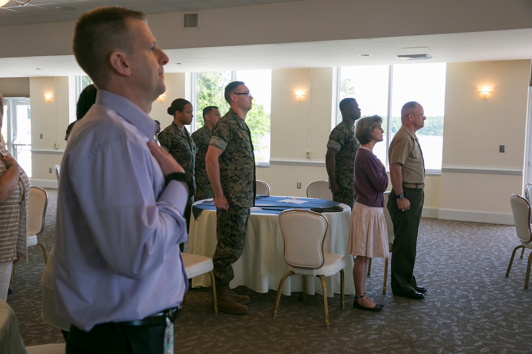 Members of the community and service members on Marine Corps Air Station New River stand for the national anthem during the National Day of Prayer at the Officers' Club on MCAS New River, May 3. The National Day of Prayer is an annual event taking place on the first Thursday of May. (U.S. Marine Corps photo by Lance Cpl. Nicholas Lubchenko)