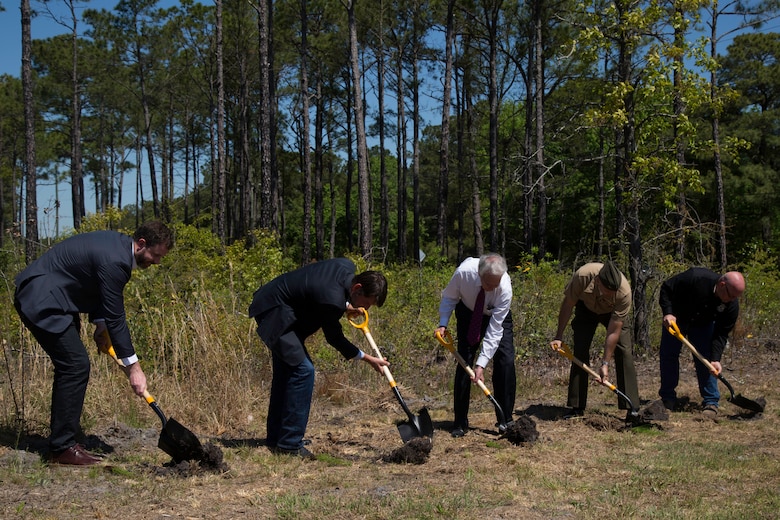 Officials with military and state and federal conservation agencies plant Longleaf Pine Seedlings at the Stones Creek Game Land on Sneads Ferry, North Carolina, April 30. The planting celebrated the Red-Cockaded Woodpecker Recovery and Sustainment Program Partnership. (U.S. Marine Corps photo by Cpl. Breanna L. Weisenberger)