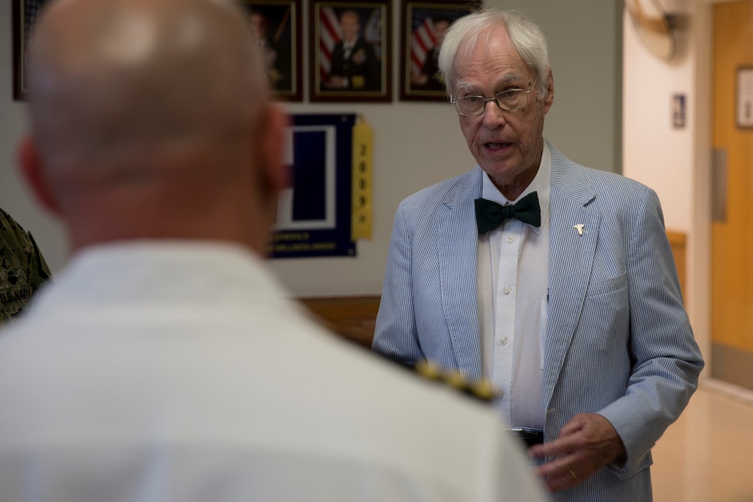 Dr. Jim Fruthaler, former Navy lieutenant junior grade reminisces with service members about his time in the military as a pediatrician at the Hadnot Point Medical Clinic located on Marine Corps Base Camp Lejeune, May 1. Dr. Fruthaler, who received orders to MCB Camp Lejeune in 1951, helped establish the first pediatric clinic on base at historic Building 15. “It is very meaningful for us to have him here today,” said Cmdr. Daniel D’Aurora, director of branch clinics. “Listening to what he had to go through to stand up this clinic is a very unique experience.” (U.S. Marine Corps photo by Lance Cpl. Nathan Reyes)