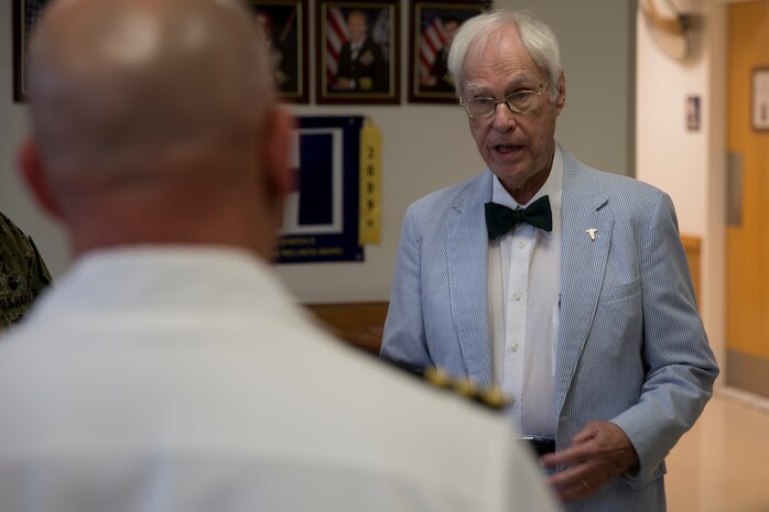 Dr. Jim Fruthaler, former Navy lieutenant junior grade reminisces with service members about his time in the military as a pediatrician at the Hadnot Point Medical Clinic located on Marine Corps Base Camp Lejeune, May 1. Dr. Fruthaler, who received orders to MCB Camp Lejeune in 1951, helped establish the first pediatric clinic on base at historic Building 15. “It is very meaningful for us to have him here today,” said Cmdr. Daniel D’Aurora, director of branch clinics. “Listening to what he had to go through to stand up this clinic is a very unique experience.” (U.S. Marine Corps photo by Lance Cpl. Nathan Reyes)