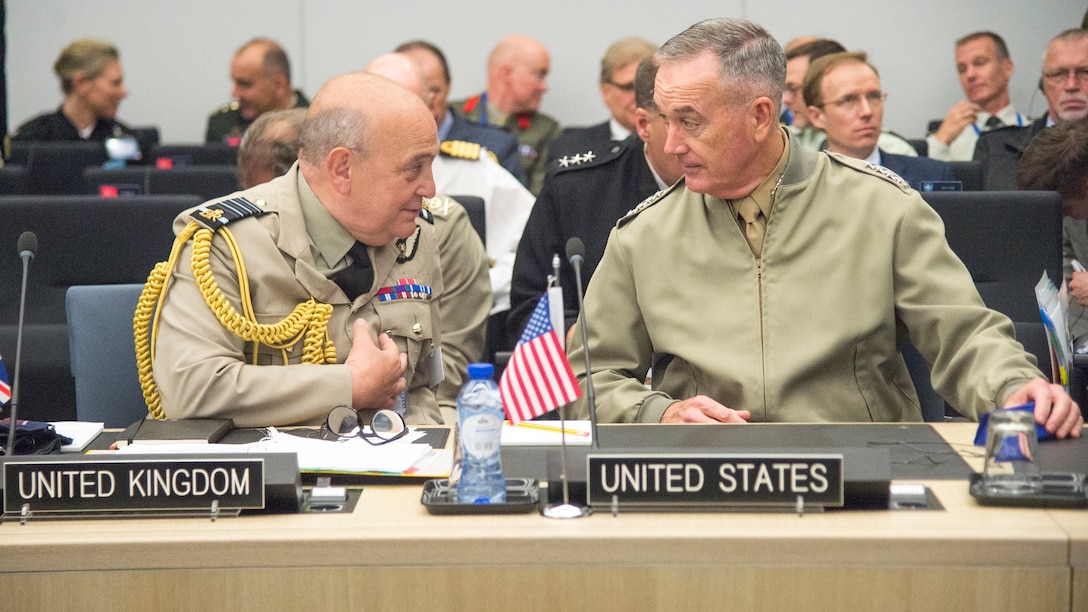 Two military leaders speak during NATO meetings in Brussels.