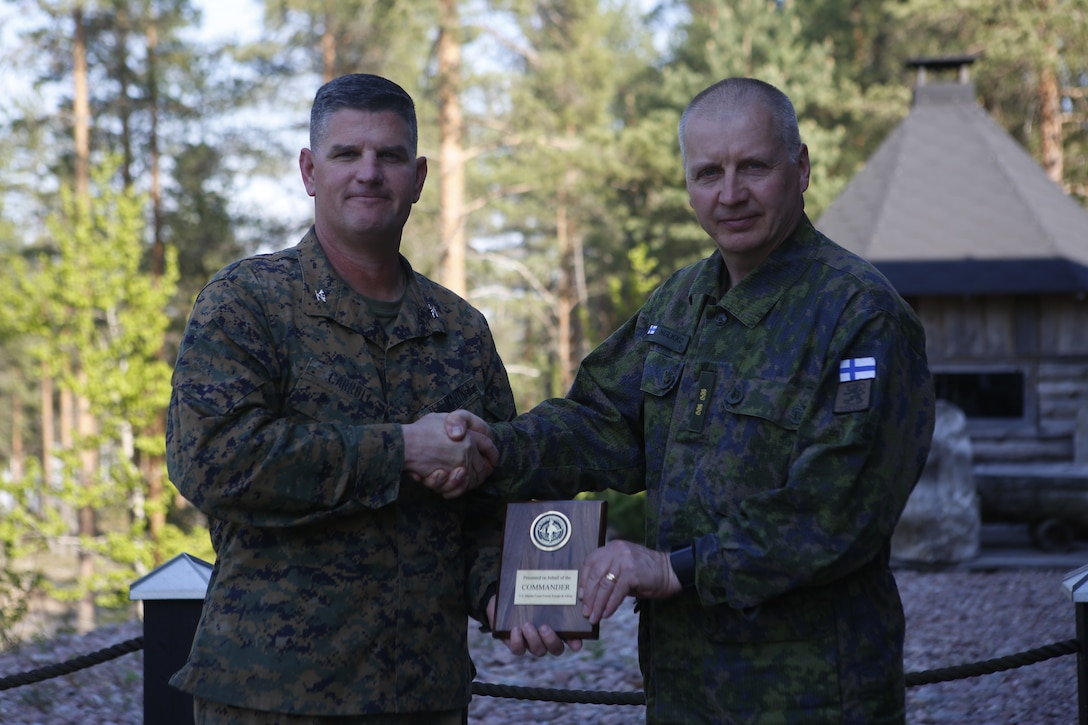 Colonel John J. Carroll, the deputy commander of Marine Forces Europe and Africa, presents Maj. Gen. Petri Hulkko, the commander of the Finnish Army, with a gift as part of a distinguished visitor tour for Exercise Arrow 18 in Finland, May 15, 2018. Exercise Arrow is an annual multi-national exercise with the purpose of training platoon- to battalion-sized mechanized infantry, artillery, and mortar field training skills with a live fire exercise. (U.S. Marine Corps photo by Sgt. Averi Coppa/Released)