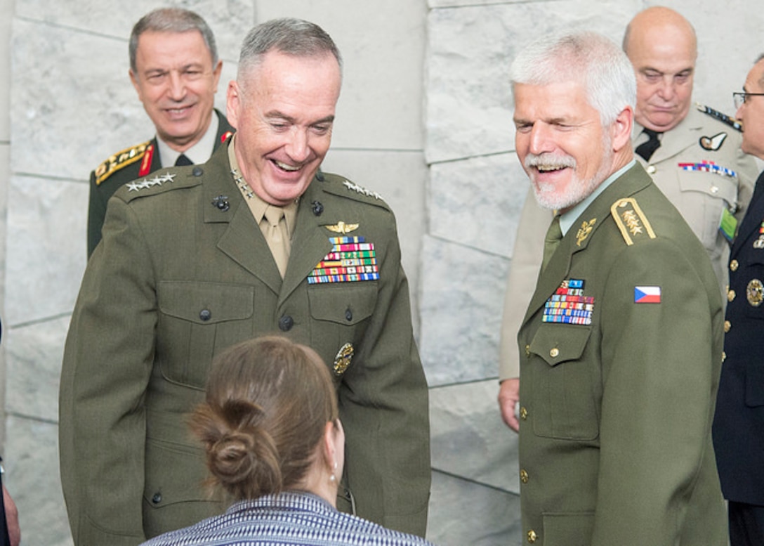 Marine Corps Gen. Joe Dunford, chairman of the Joint Chiefs of Staff, left, arrives to attend the 179th Military Committee in Chiefs of Defense meeting at NATO’s new headquarters building in Brussels, May 16, 2018. Standing next to Dunford is Czech Gen. Petr Pavel, the chairman of NATO’s Military Committee.