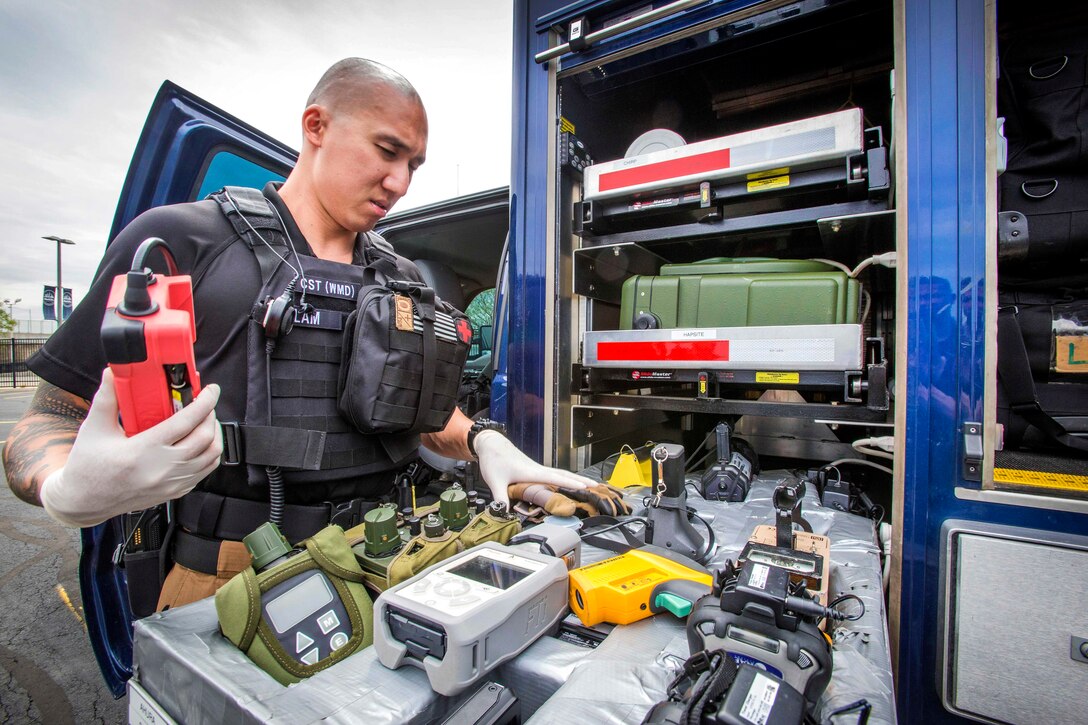 A soldier selects chemical and radiation detection equipment.