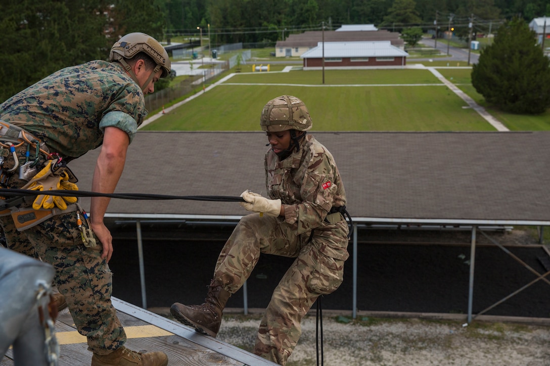 Private Tamairah Darrell, soldier for Royal Bermuda Regiment, faces her fear as she repels down during the rappel tower at Stone Bay on Marine Corps Base Camp Lejeune on May 8, 2018. The regiment was at MCB Camp Lejeune for a two week evolution, the Junior Noncommissioned Officer Cadre, which includes scenario-based exercises, rappelling, section attacks and section battle drills. (U.S. Marine Corps photo by Lance Cpl. Dominique Fisk)