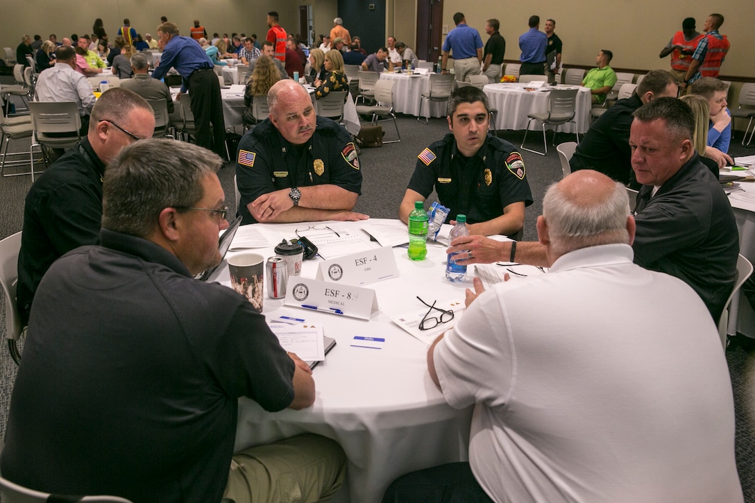 Representatives for the first responders for Onslow County discuss the actions they would take during different stages of a category four hurricane during the simulated worst-case scenario Category Four Hurricane Table Top Exercise at the Onslow County Government Complex, May 1. Onslow County has never had to a full evacuation, but this exercise allowed them to bring up the problems and tactics if such an event were to happen. (U.S. Marine Corps photo by Lance Cpl. Nicholas Lubchenko)