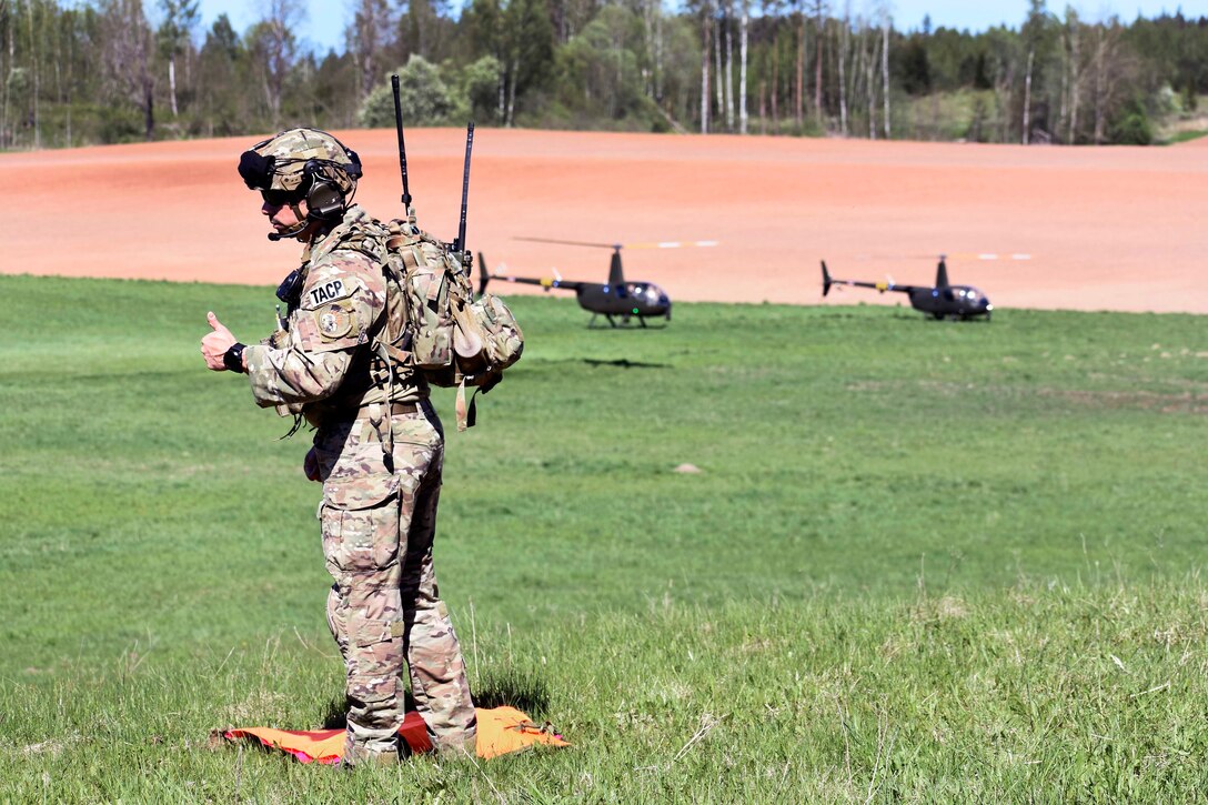 An airman uses hand signals during an exercise.