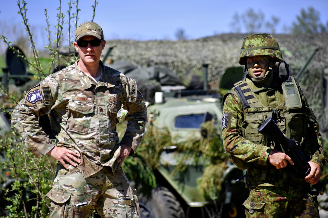 An airman advises an Estonian defense forces member.